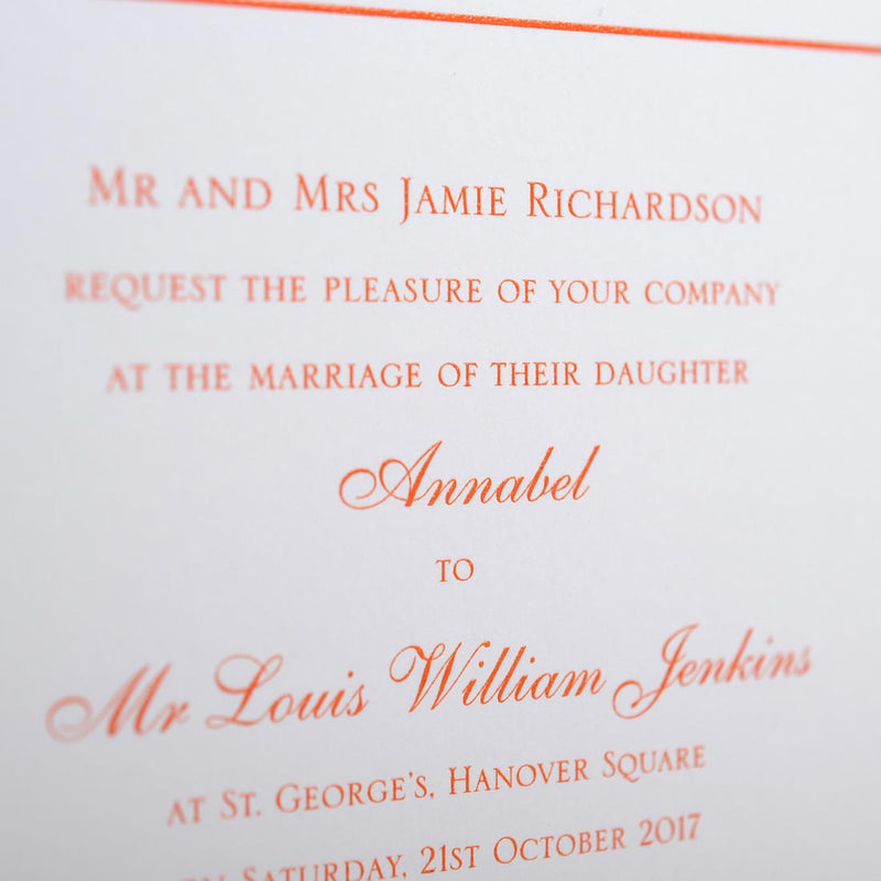 a close up of the Mayfair wedding invitation wording, printed in orange onto white card