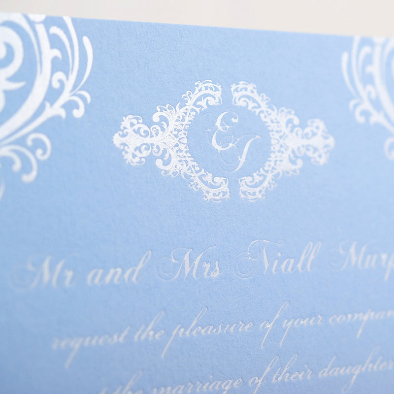 a close up of the intricate monogram at the head of the merrion wedding invitation