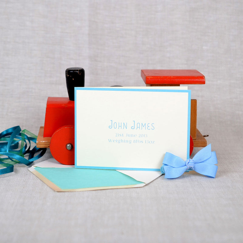 The Mountjoy personalised new baby cards, showing a baby blue baby writing font with matching border