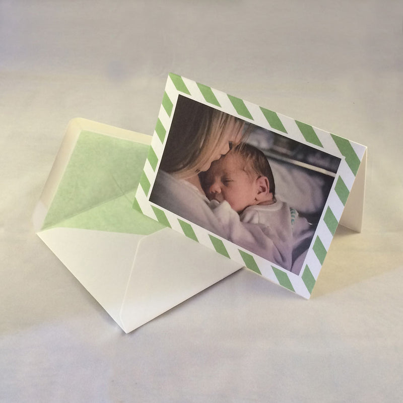 The olivia baby photo thank you cards, showing sage green striped borders which complement the tone in the picture