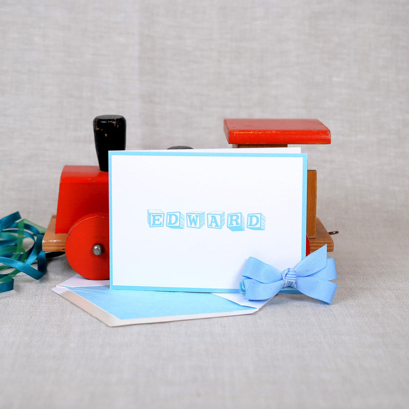 The Ottershaw personalised new baby cards, showing a blue baby blocks font with matching borde