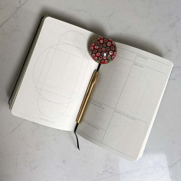 The inside pages are printed with a table plan and a facing page with room for annotations