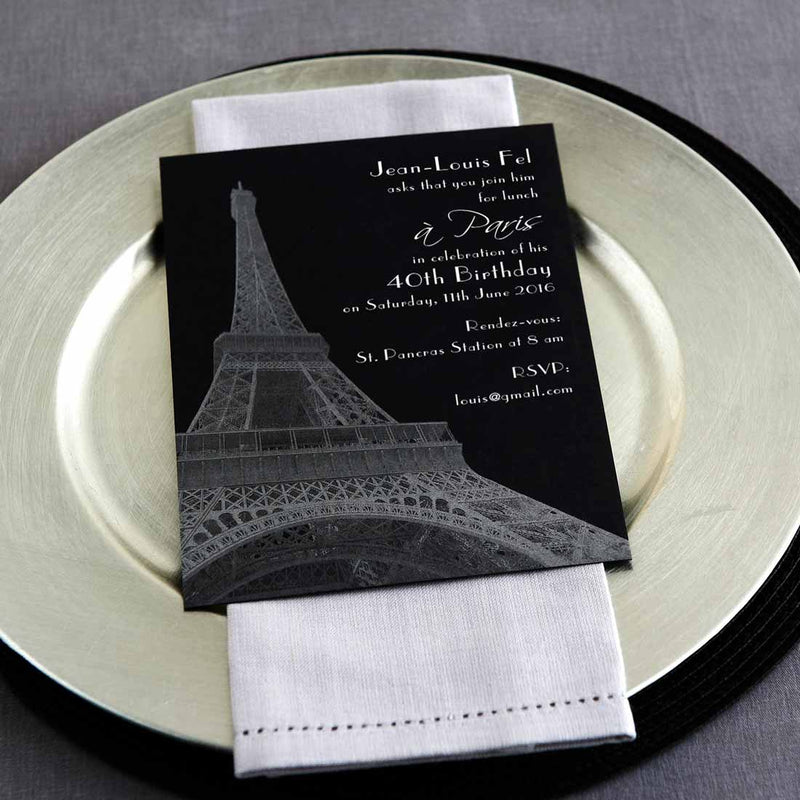The Paris Party invitations lying on a silver plate, showcase the silver inks printing of the Eiffel Tower