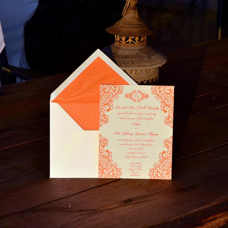 The Parnell Wedding invitation against a dark wood background