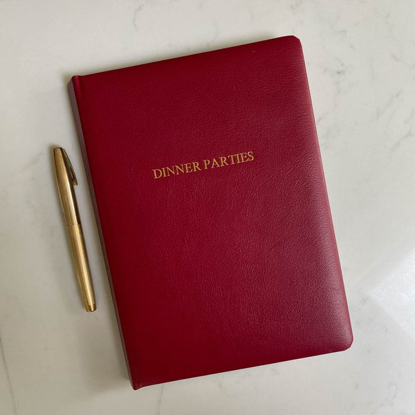Embossed in gold this red leather dinner party book can be personalised