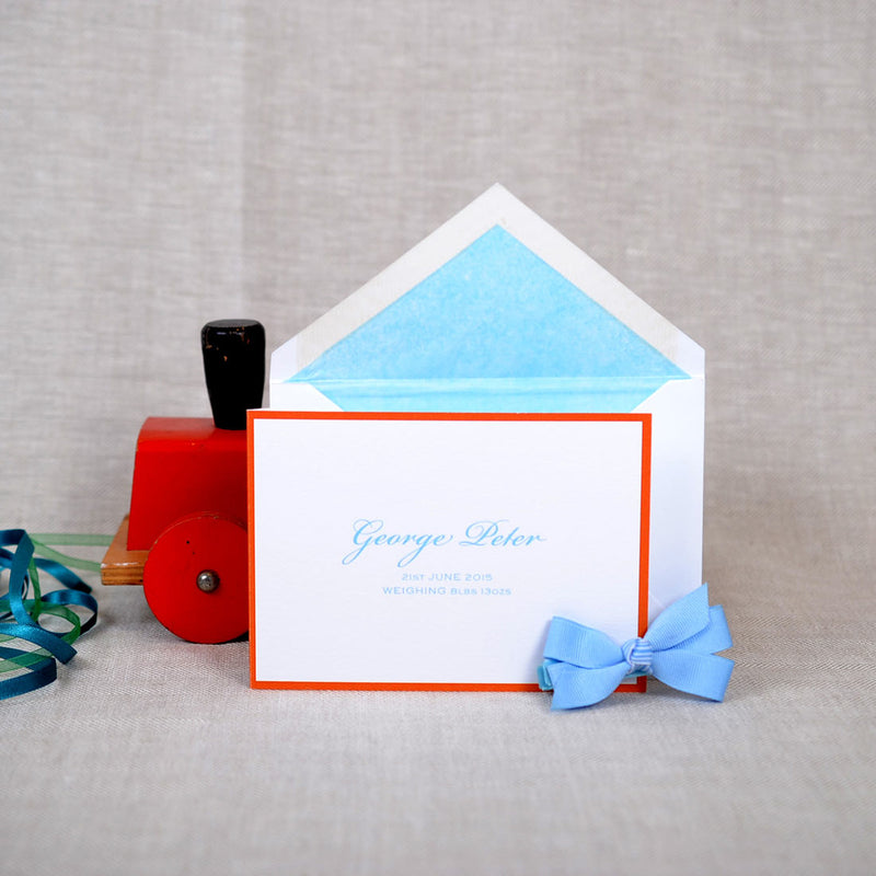 The folded Roslair birth announcement cards and envelope with blue tissue paper lining 