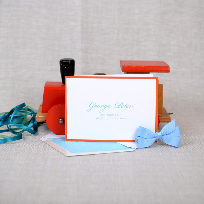 The Roslair personalised new baby cards, showing a blue font and orange border
