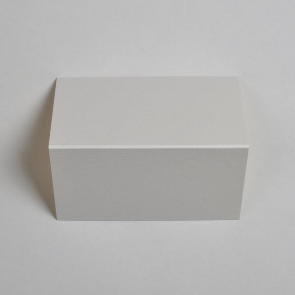 The textured cream wedding place cards show top down