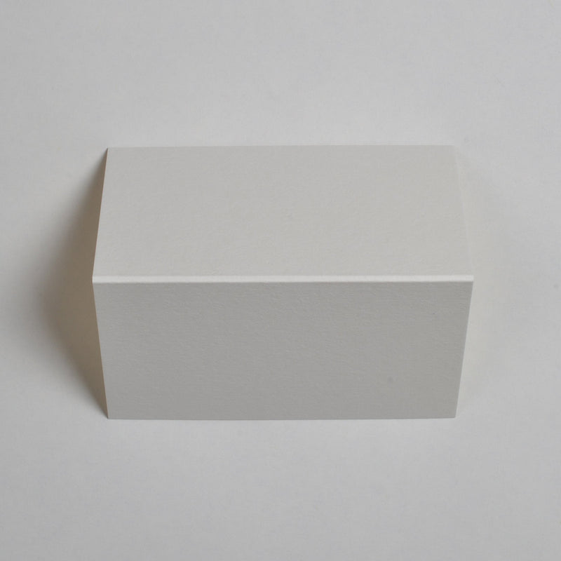 The textured cream wedding place cards show top down