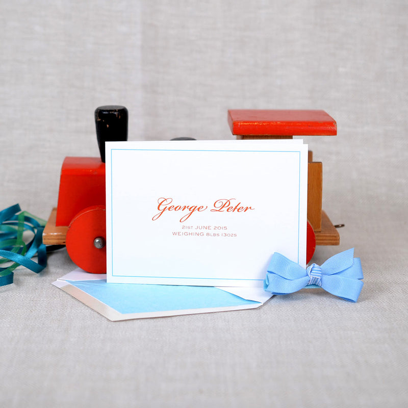 The Torville personalised new baby cards, showing an orange font and baby blue keyline border