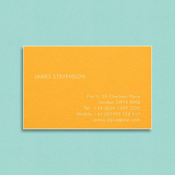 The Vale visiting cards show white ink engraved onto a citrine card which is finished with white edges