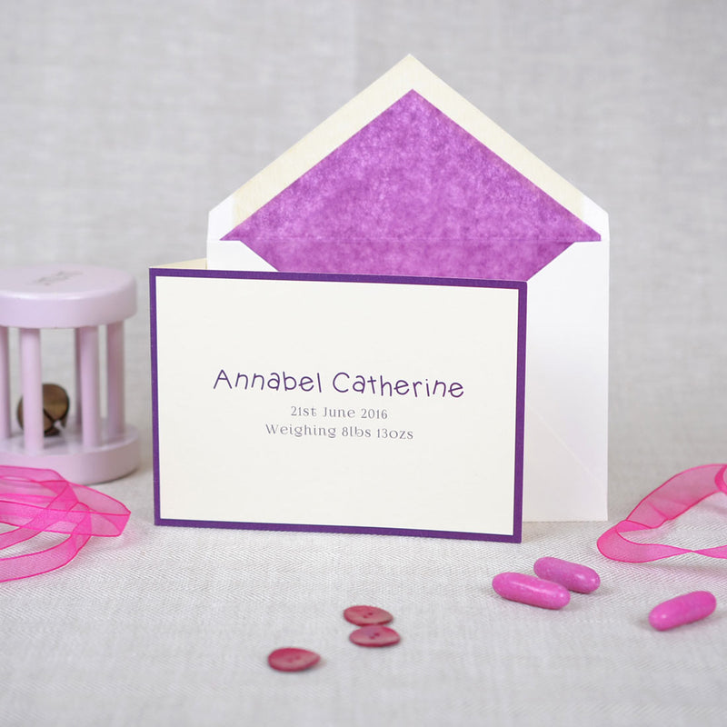 The folded Walton birth announcement cards and envelope with purple tissue paper lining 