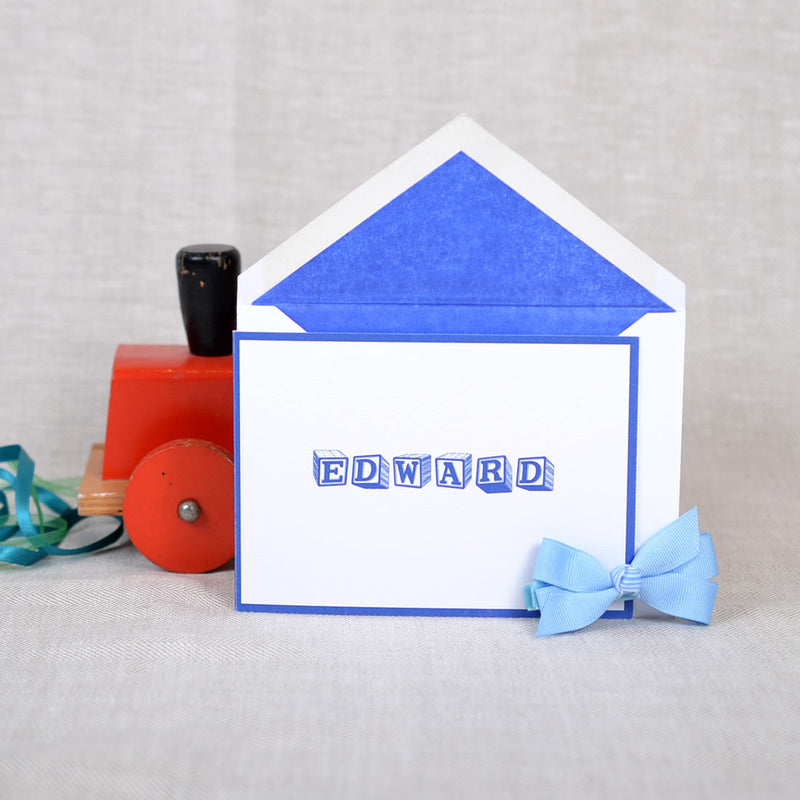 The folded Welling birth announcement cards and envelope with pacific blue tissue paper lining