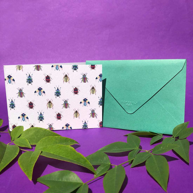 he landscape bugtopia card, with the fold on the short side with it's emerald green envelope