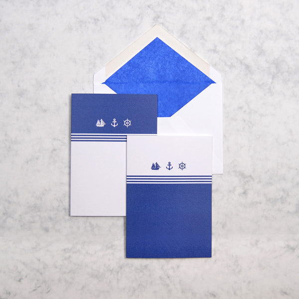the blue and white Cannes nautical greeting cards show 3 nautical motifs on portrait cards, with navy blue tissue paper lined white envelopes