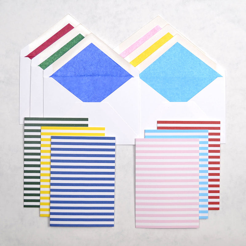 the deck chair pattern greeting cards show horizontal stripes on a portrait card, shown with matching tissue paper lined white envelopes