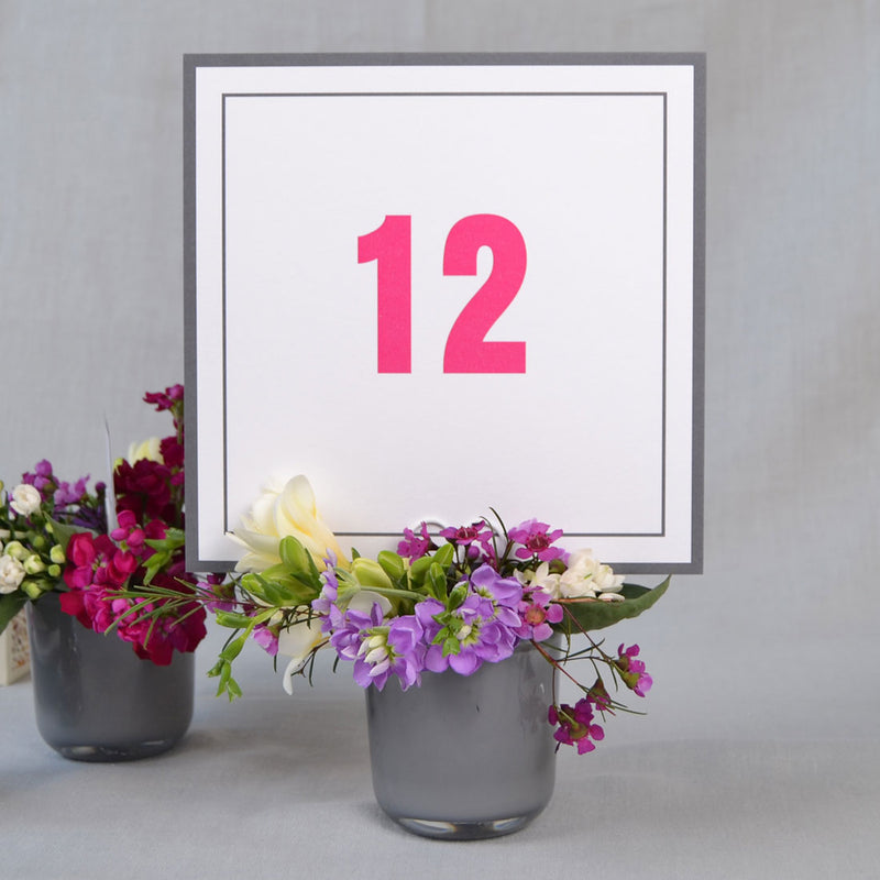 The farringdon personalised table number cards use a grey border with table name printed in contrasting shocking pink