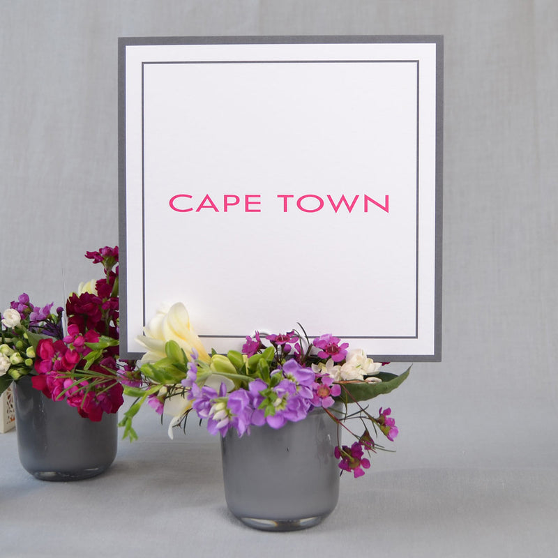 The square Farringdon wedding table name cards print with a Grey border and shocking pink personalised name