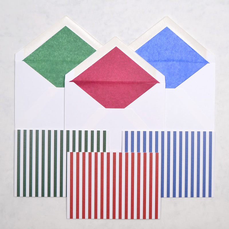 the fun fair pattern greeting cards show vertical stripes on landscape cards, shown with matching tissue paper lined white envelopes