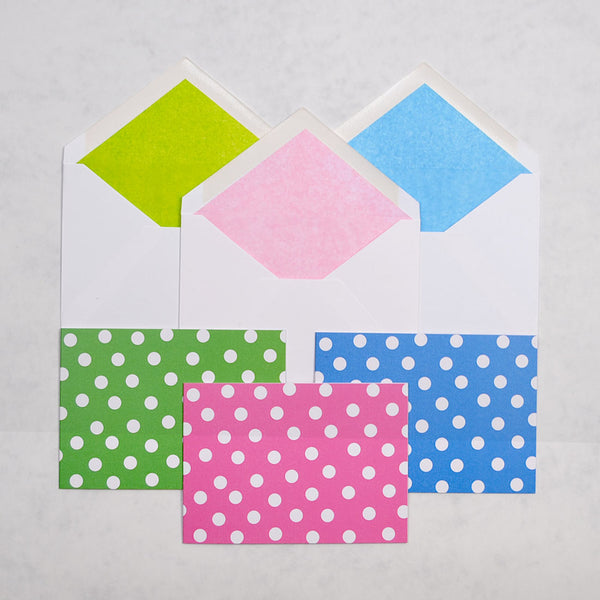 the get spotted greeting cards show 3 pastel colour ways of a polka dot pattern on landscape cards, with matching tissue paper lined white envelopes