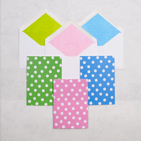 the hit the spot greeting cards show 3 colour ways of a polka dot pattern on portrait cards, with matching tissue paper lined white envelopes