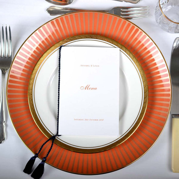 The Mayfair wedding menus, use a a black tassle around the spine of the folded menu card to contrast against the orange ink
