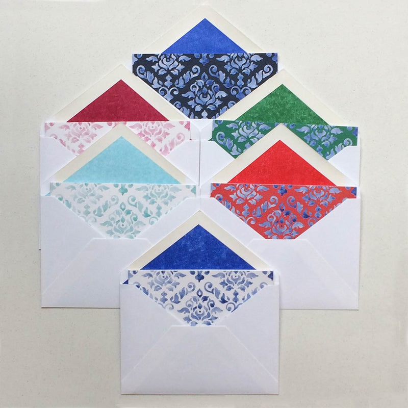 the mixed colours of the damask pattern greeting cards shown fanned out with matching tissue paper lined envelopes