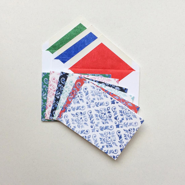 the mixed colours of the damask pattern greeting card shown in their white envelopes which are lined with matching tissue paper