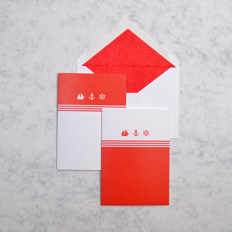the red and white Monaco nautical greeting cards show 3 nautical motifs on portrait cards, with matching bright red tissue paper lined white envelopes