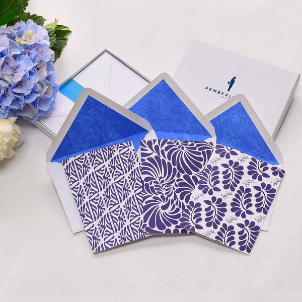 the oaxaca blues greeting cards shows the different patterns of tropical leaves printed in blue with matching blue tissue lining in the white envelopes