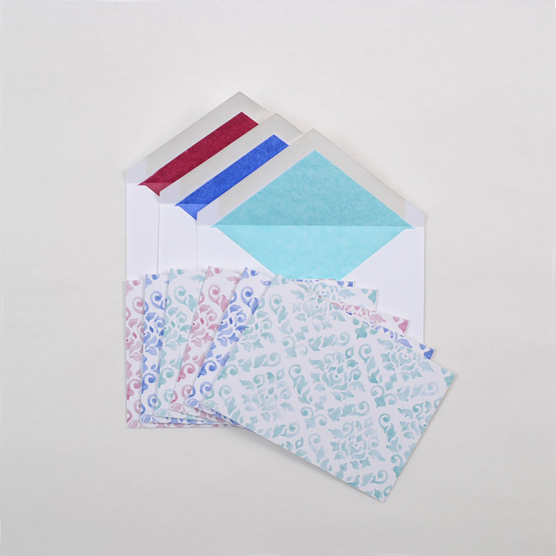 the pastel shades of damask pattern greeting cards shown fanned out with matching tissue paper lined envelopes