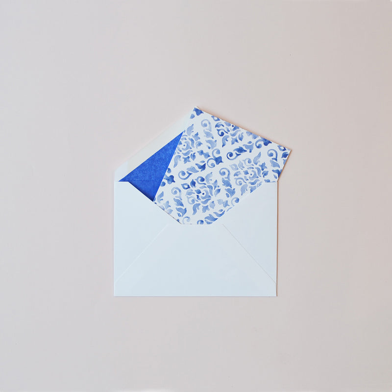 the pastel blue damask pattern greeting card shown in their white envelopes which are lined with matching tissue paper