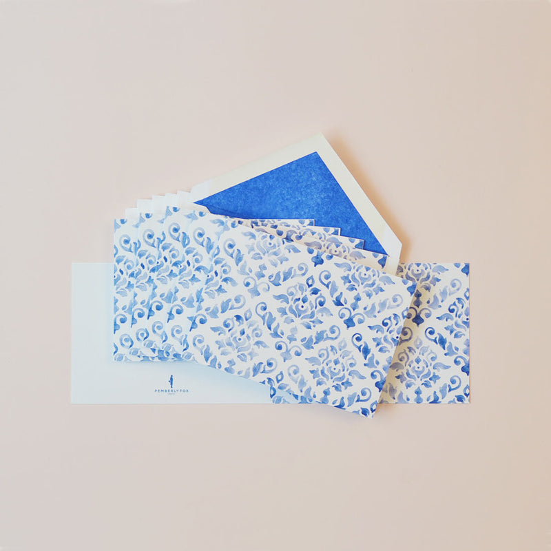 the pastel blue damask pattern greeting cards shown fanned out with matching tissue paper lined envelopes