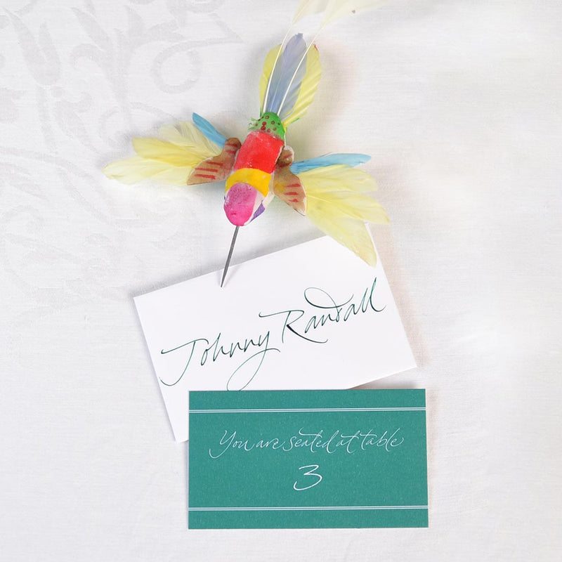 The Portland wedding escort cards are personalised and show your guest's table number in a calligraphy font printed white out of solid green.