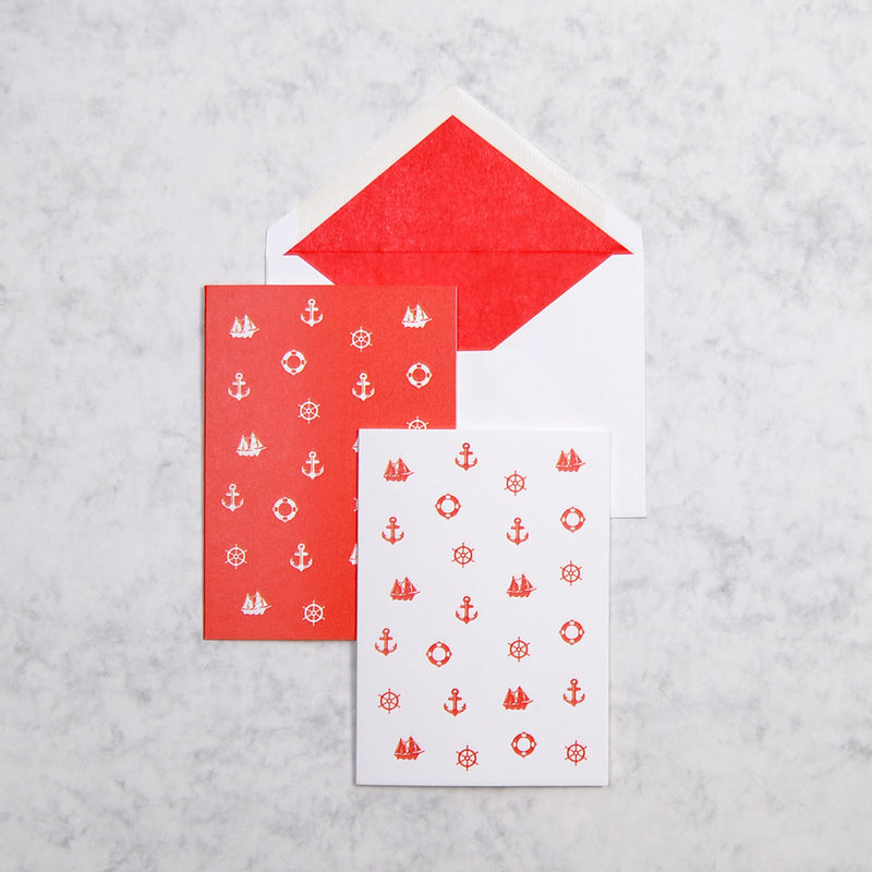 the red and white Portofino nautical greeting cards show 3 nautical motifs as a pattern on portrait cards, with bright red tissue paper lined white envelopes