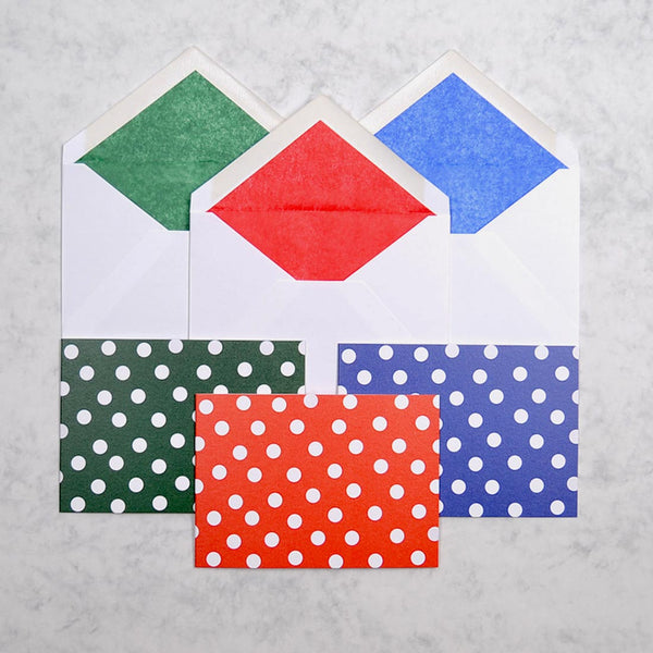 the spot on greeting cards show 3 colour ways of a polka dot pattern on landscape cards, with matching tissue paper lined white envelopes