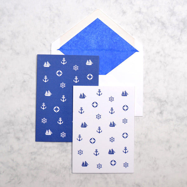 the blue and white St Tropez nautical greeting cards show 3 nautical motifs as a pattern on portrait cards, with navy blue tissue paper lined white envelopes