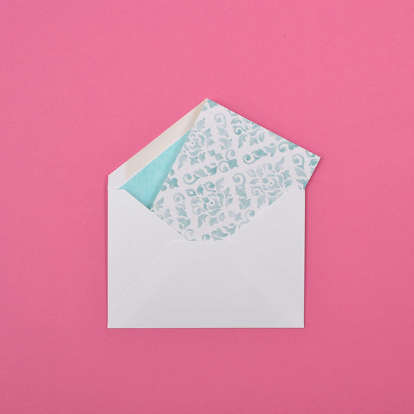 the teal damask pattern greeting card shown in their white envelopes which are lined with matching tissue paper